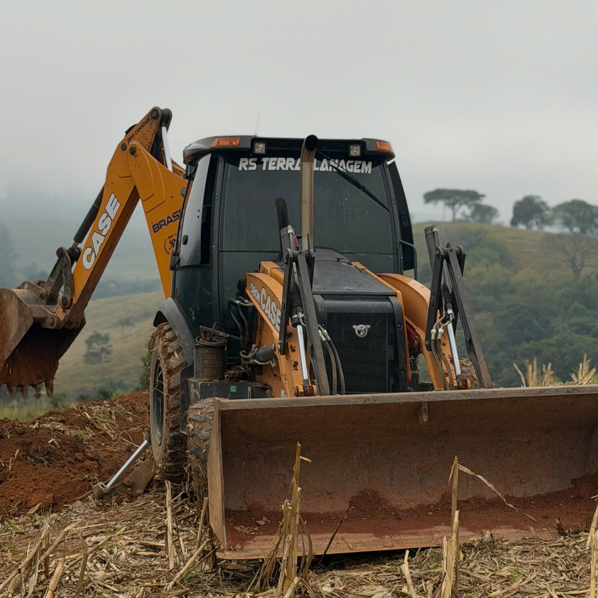 Escavadeira trabalhando em área de terraplanagem